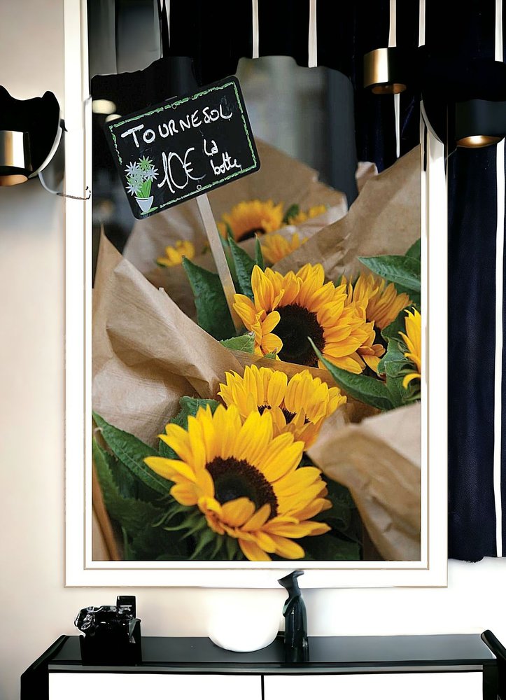 Bouquet of sunflowers with a decorative sign in a mirror frame.