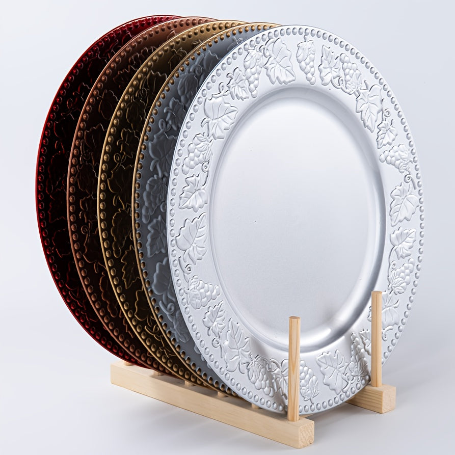 Set of decorative plates on a wooden stand against a plain background