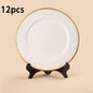 A white and gold decorative charger plate with an intricate floral pattern around the edge, measuring 33 cm (13 inches).