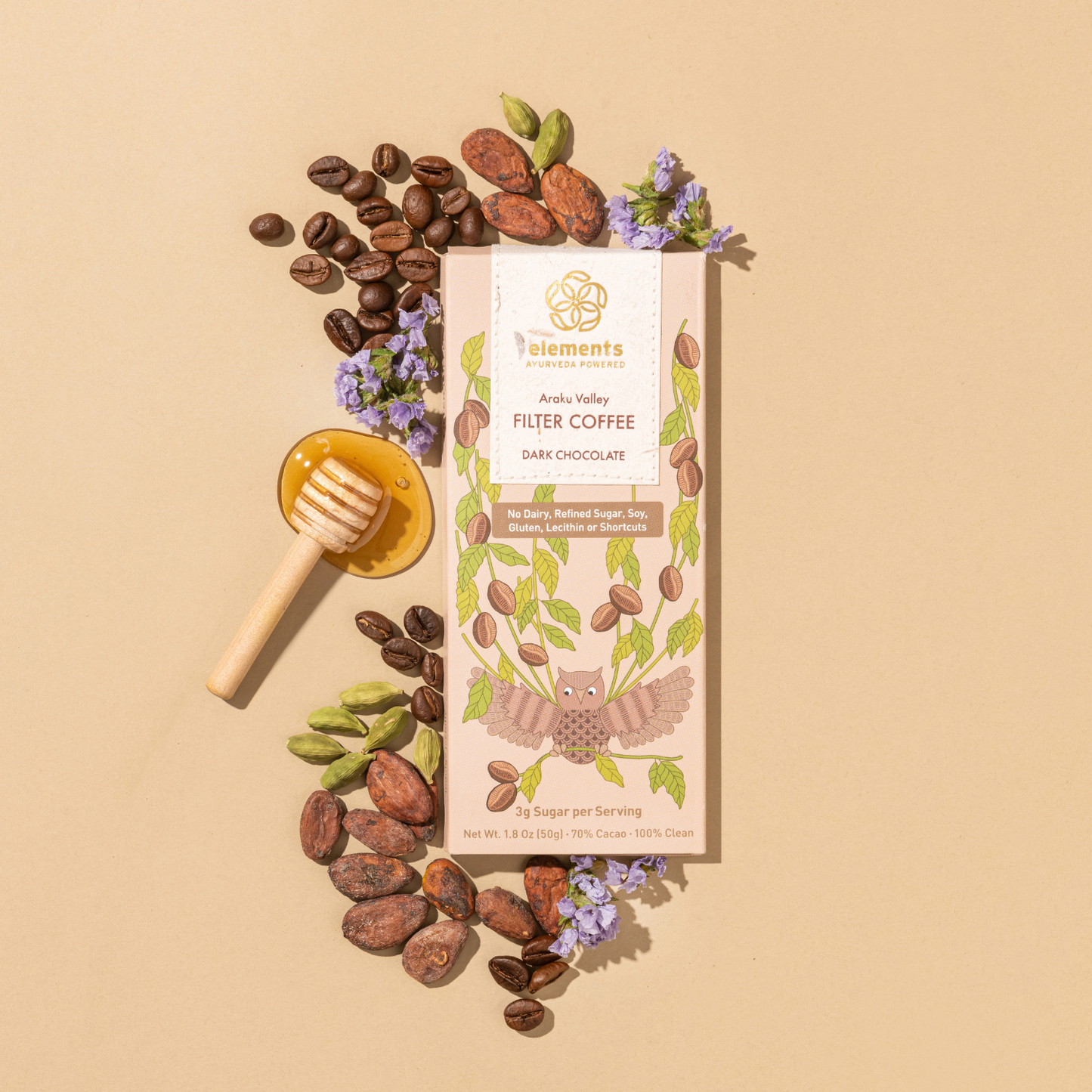 Filter coffee package with coffee beans, honey dipper, and flowers on a beige background