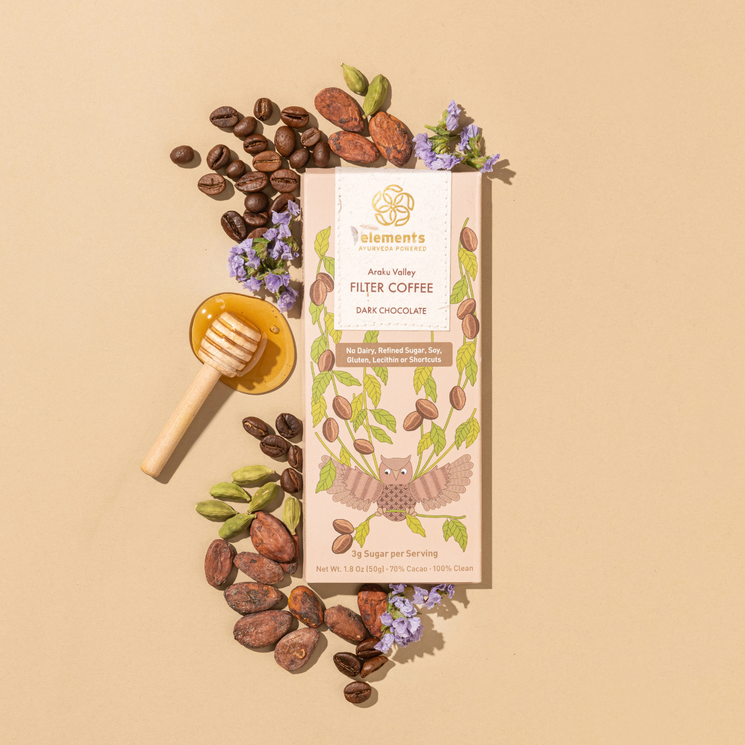 Filter coffee package with coffee beans, honey dipper, and flowers on a beige background