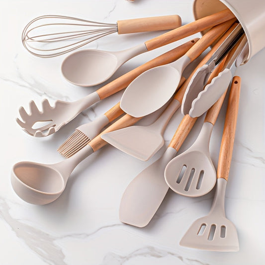 A collection of grey silicone kitchen utensils with wooden handles, displayed alongside a kitchen aid stand.