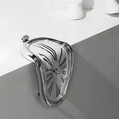 Metallic clutch bag with decorative pattern on a white surface