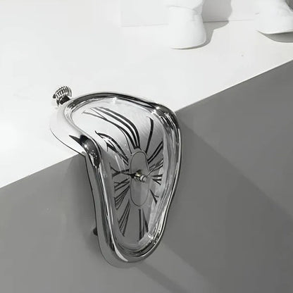 Metallic clutch bag with decorative pattern on a white surface