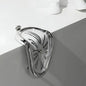Metallic clutch bag with decorative pattern on a white surface