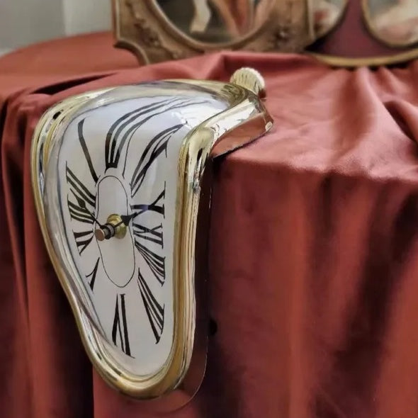 Surreal clock with melting effect on a red fabric background
