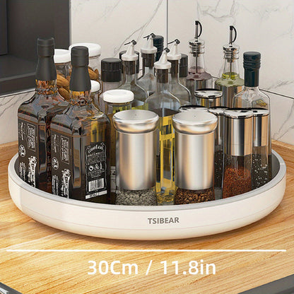 A 360-degree rotating white kitchen organizer with a selection of bottles and containers on a circular base, placed on a kitchen counter.