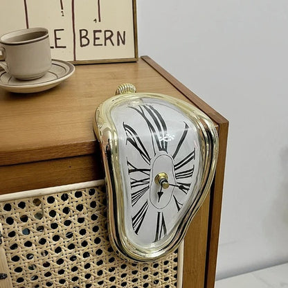 Vintage-style clock on a wooden surface with a cup and saucer in the background.