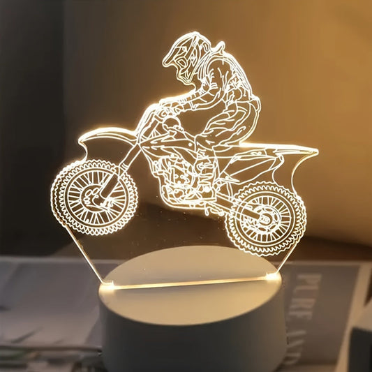 3D Motocross LED night light with a USB cord, displaying a 3D pattern of a motocross rider on a tabletop.