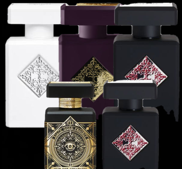 Collection of perfume bottles with decorative labels on a black background
