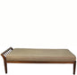 Beige cushioned bench with wooden frame on a white background