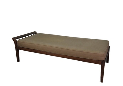 Wooden bench with a beige cushion on a white background