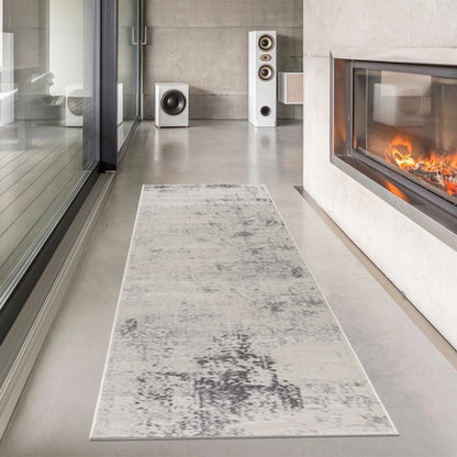 Modern living room with a runner rug, speakers, and a fireplace.