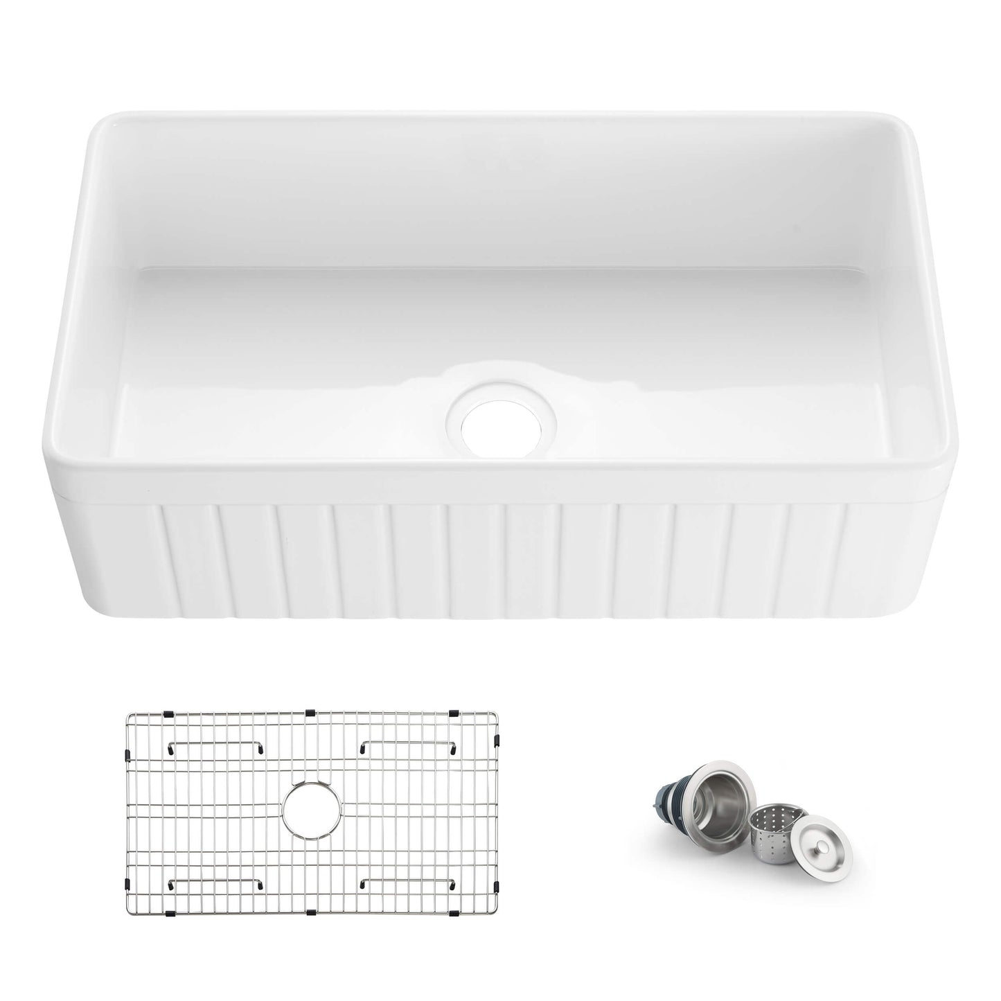 White kitchen sink with grid and drain assembly on a white background