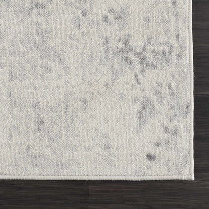 Close-up of a textured gray rug on a wooden floor
