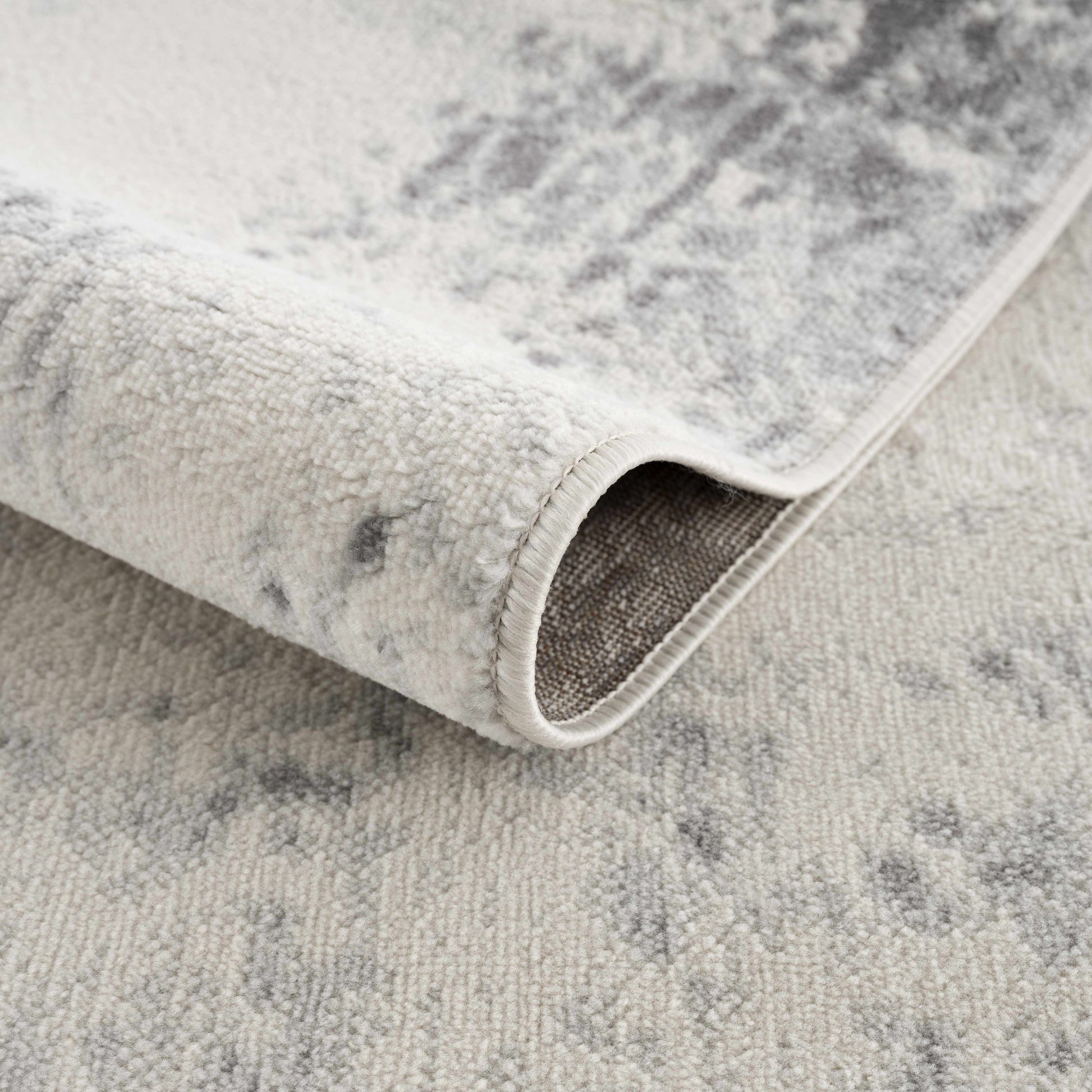 Close-up of a textured gray rug with a slight pattern.