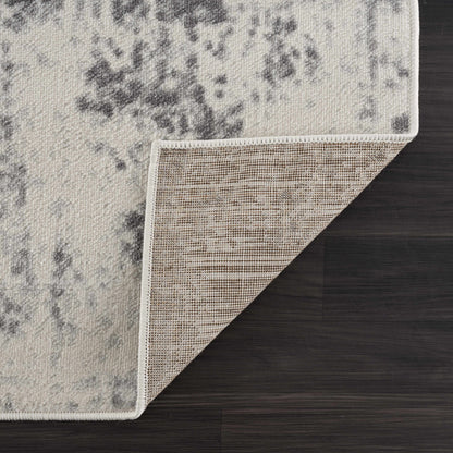 Close-up of a textured rug corner on a wooden floor