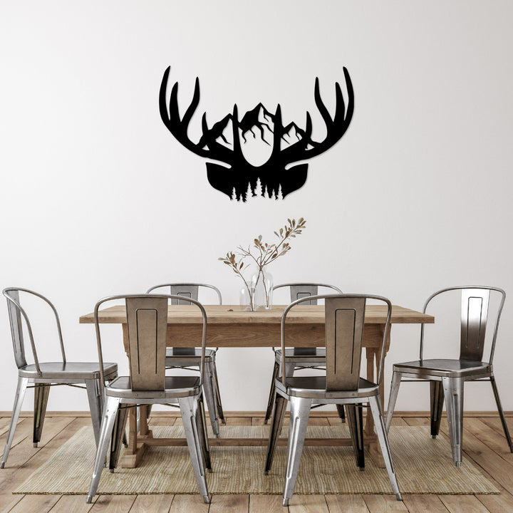 Dining room with a wooden table and chairs, featuring a large black deer antler wall decal.