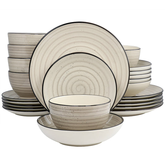 A 24 piece round stoneware dinnerware set in cream color with swirl and speckle design, including plates, bowls, and cups.