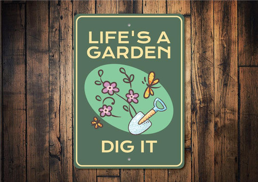 Decorative sign with 'Life's a Garden, Dig It' text and gardening illustrations on a wooden background.