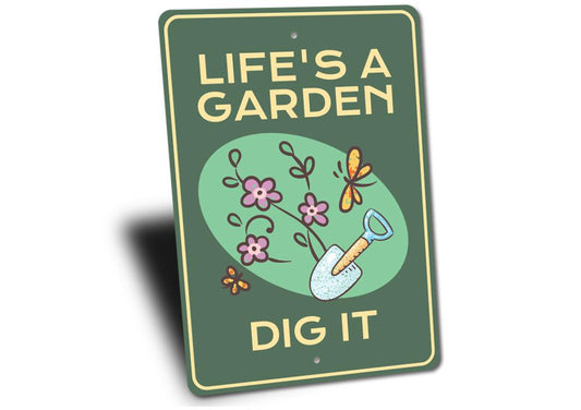 Green sign with 'Life's a Garden, Dig It' text and gardening illustrations on a white background