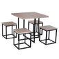 A five piece kitchen dining set with a square natural wood table and four black steel chairs with a scissor mechanism for the chairs to tuck under the table.