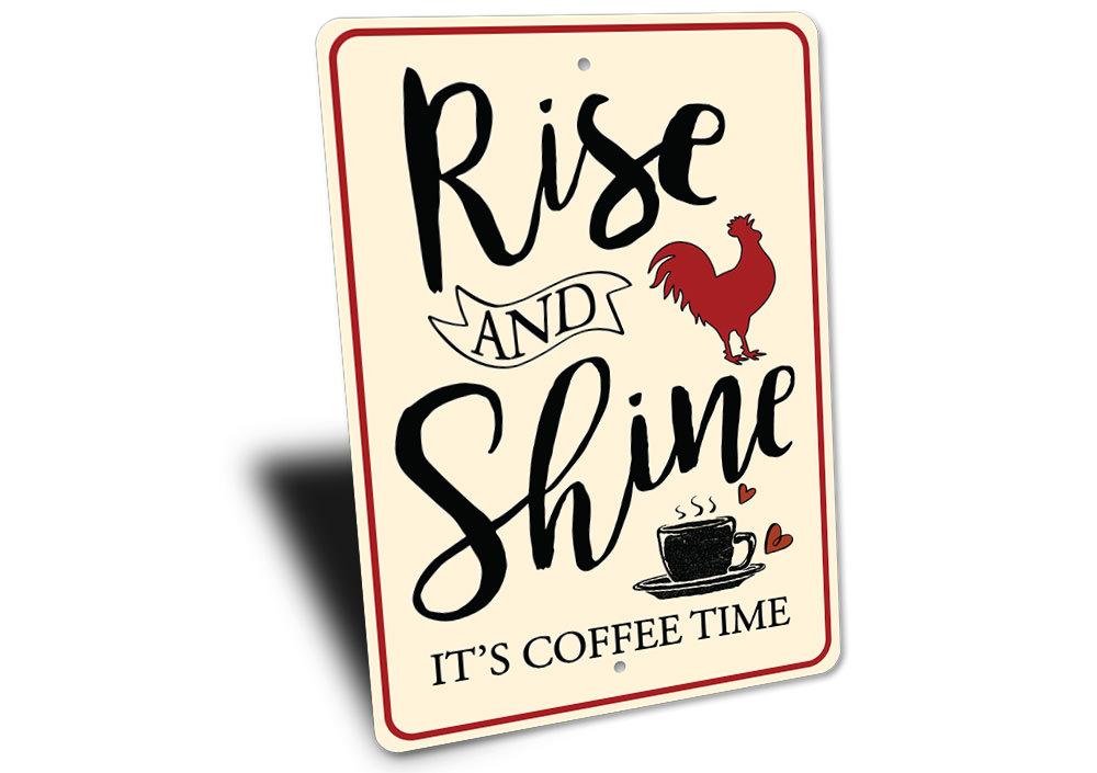 Decorative sign with text 'Rise and Shine, It's Coffee Time' featuring a rooster and coffee cup on a white background.