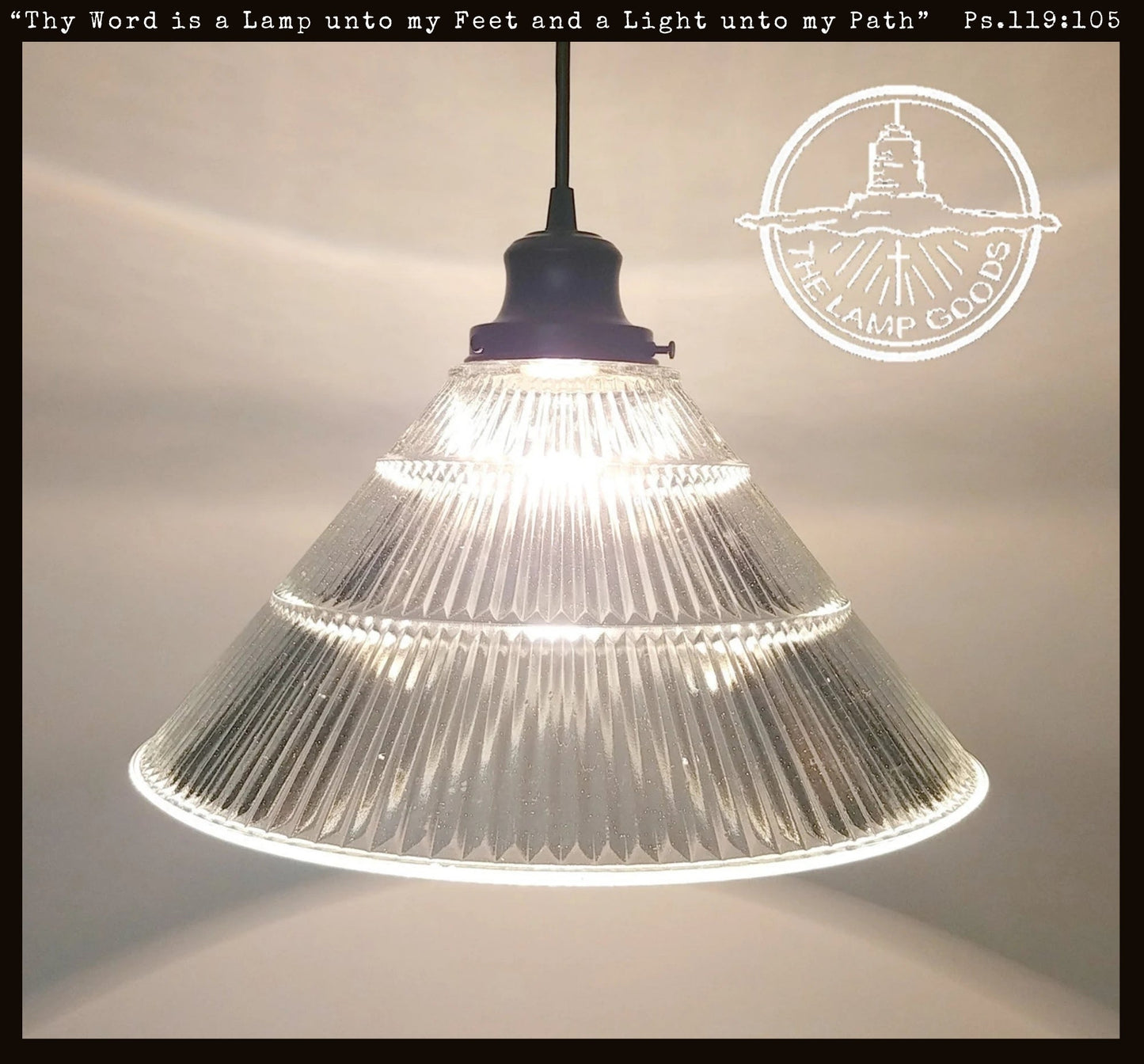 Clear glass pendant light with text and logo on a neutral background