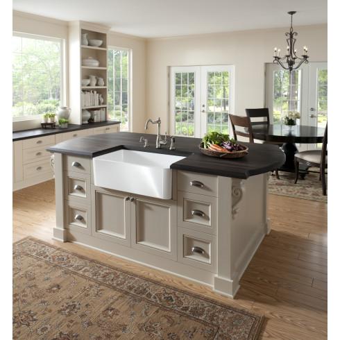 Modern kitchen with a central island featuring a farmhouse sink.