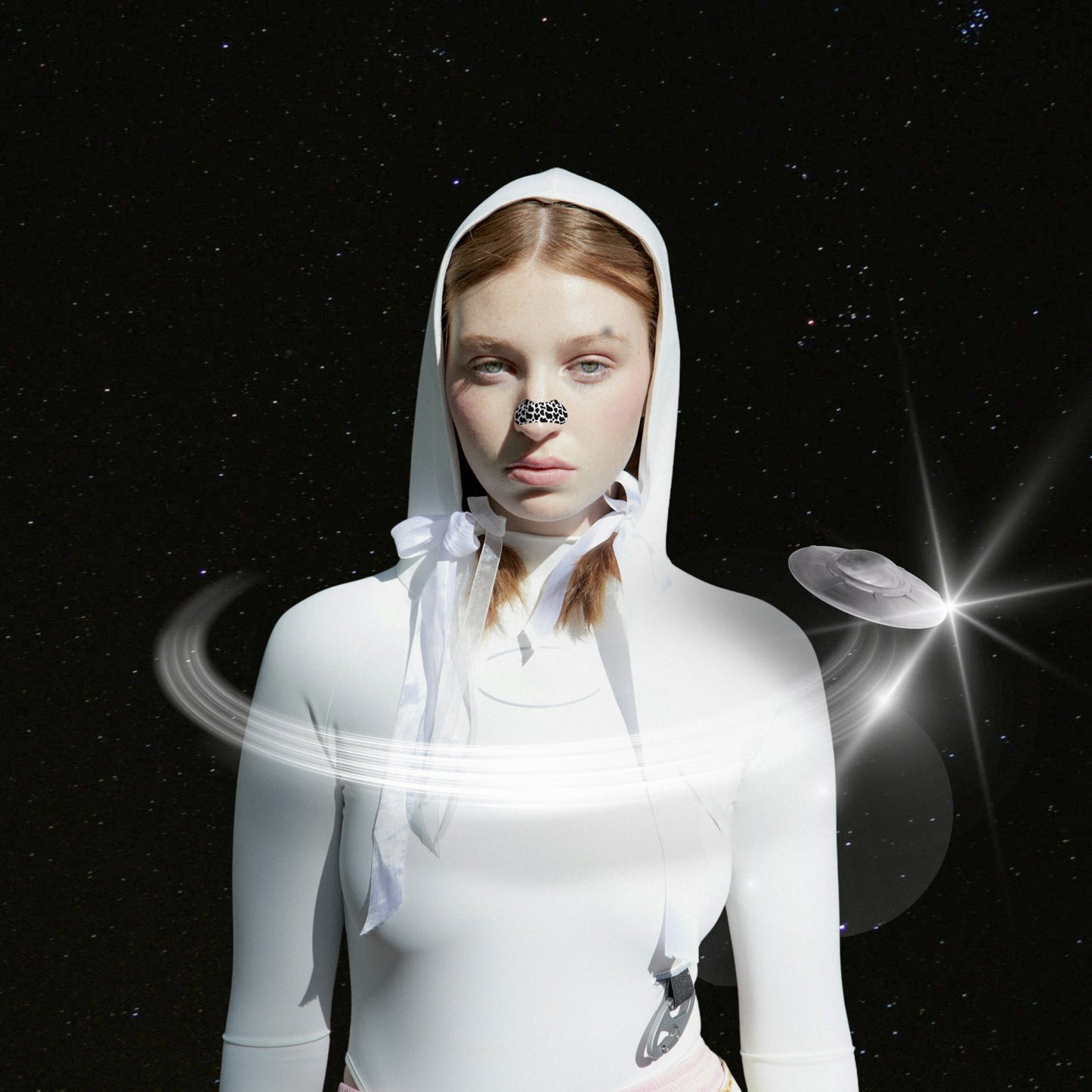 Person wearing a white hooded outfit with space-themed elements on a dark background