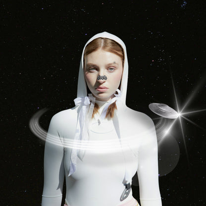 Person wearing a white hooded outfit with space-themed elements on a dark background