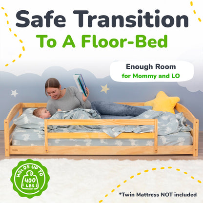 Wooden floor-bed with a child and adult reading, suitable for a safe transition to a floor-bed.