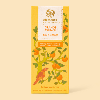 Dark chocolate bar packaging with orange crunch flavor on a beige background