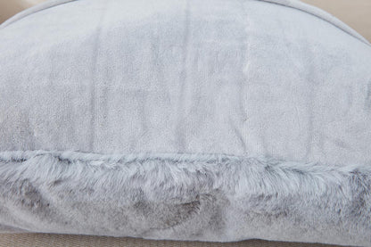 Gray cushion with fur trim on a beige background