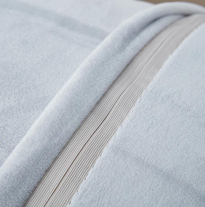 Close-up of light gray fabric with a ribbed texture