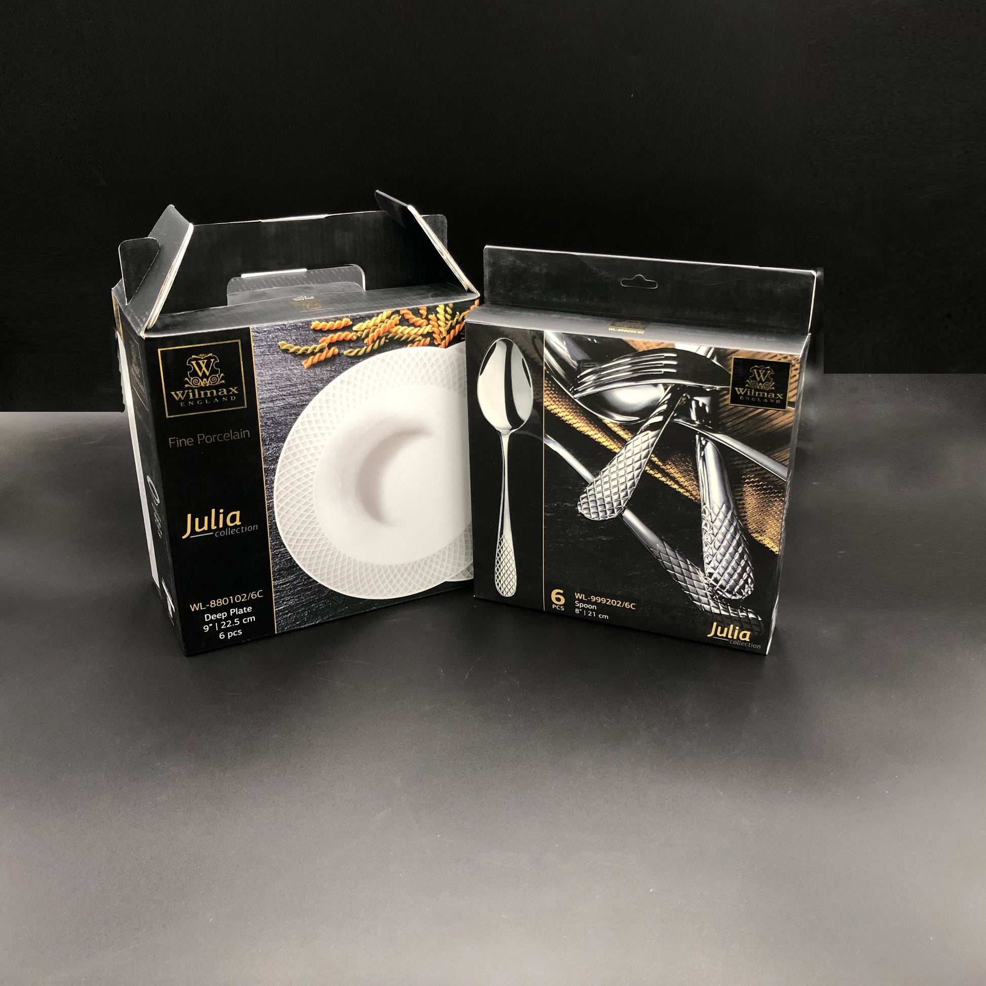 A set of fine porcelain deep plates and stainless steel dinner spoons with herringbone embossed effect, packaged in a black gift box with gold accents.