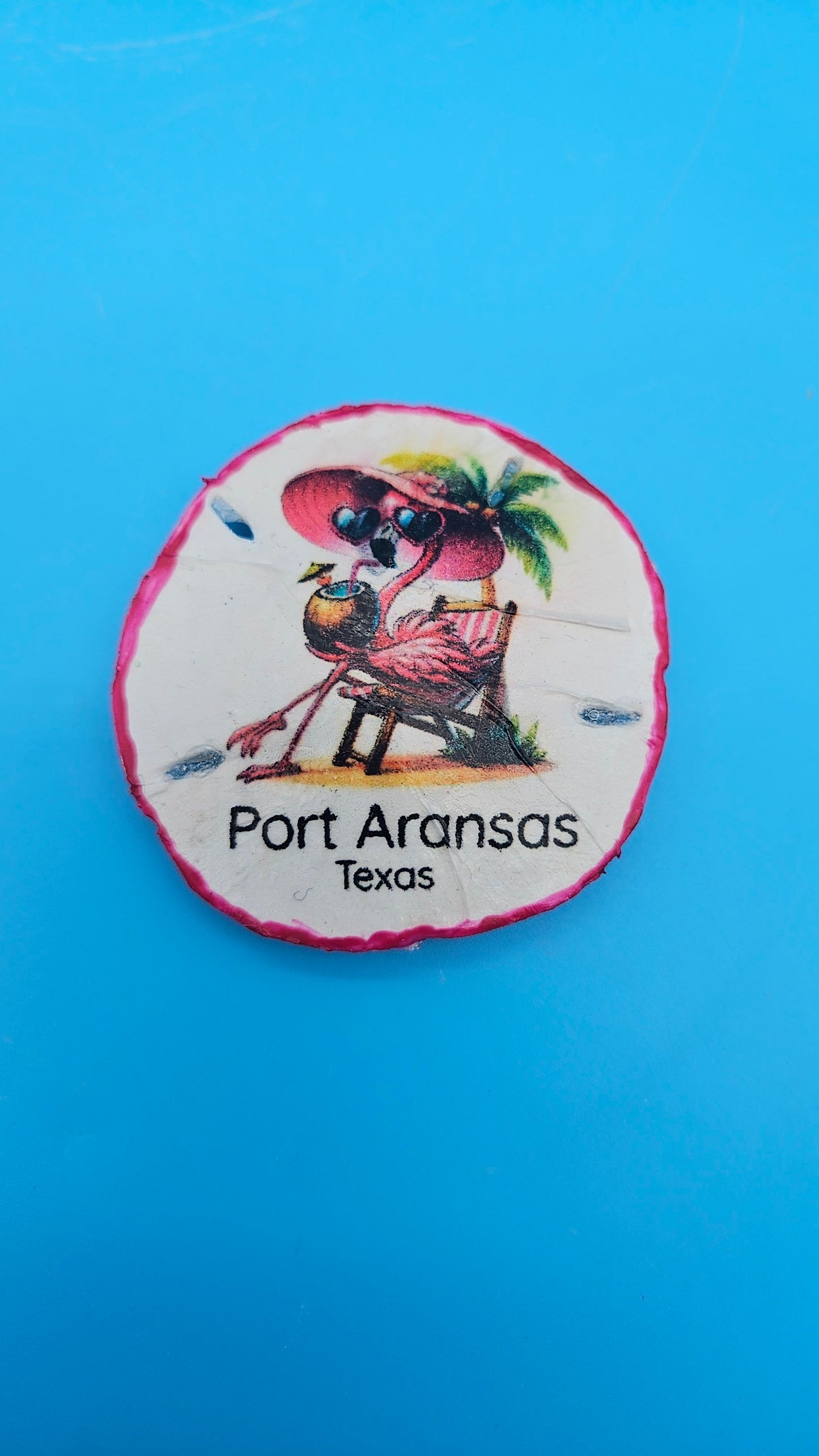 Handmade Port Aransas sand dollar magnet with flamingo design