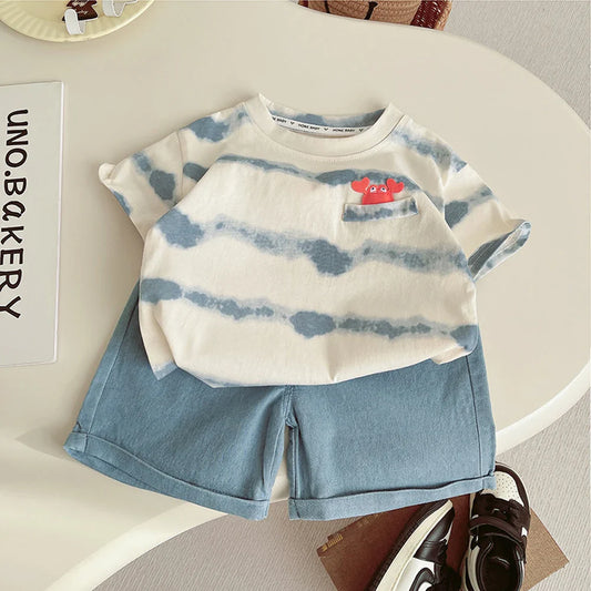 Children's outfit with striped shirt and shorts on a white surface