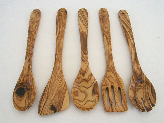 A set of five olive wood kitchen utensils including a sauce spoon, spoon, spork, cooking spoon, and spatula, displayed against a white background.