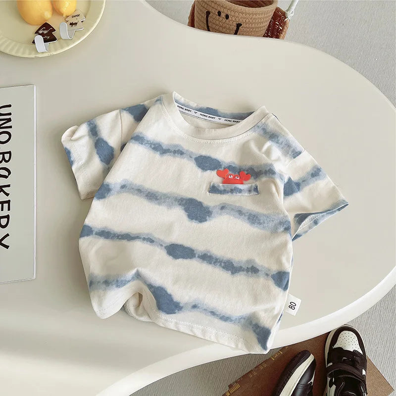 Children's t-shirt with blue and white pattern on a white surface