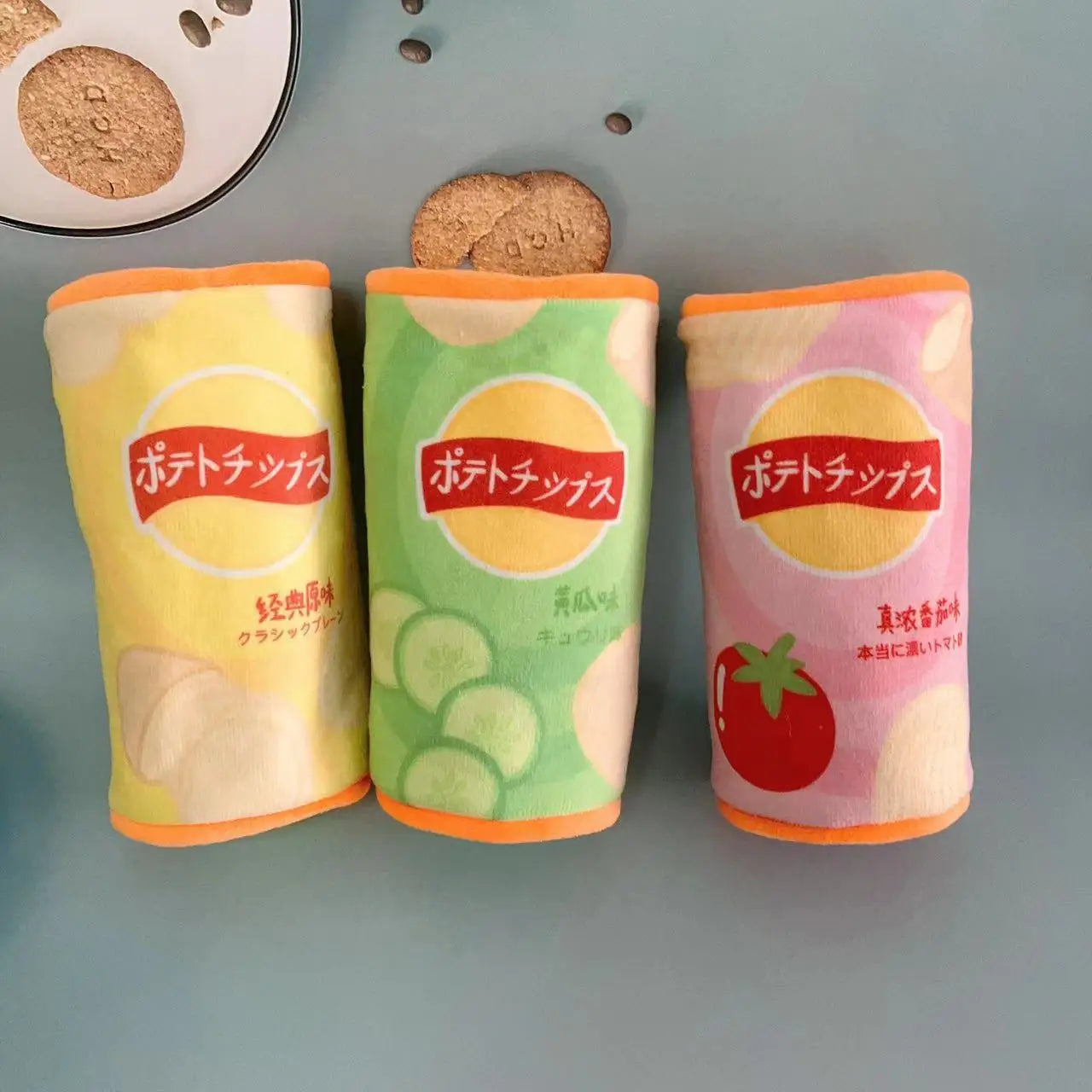 Three colorful potato chip packages with Japanese text on a gray surface.