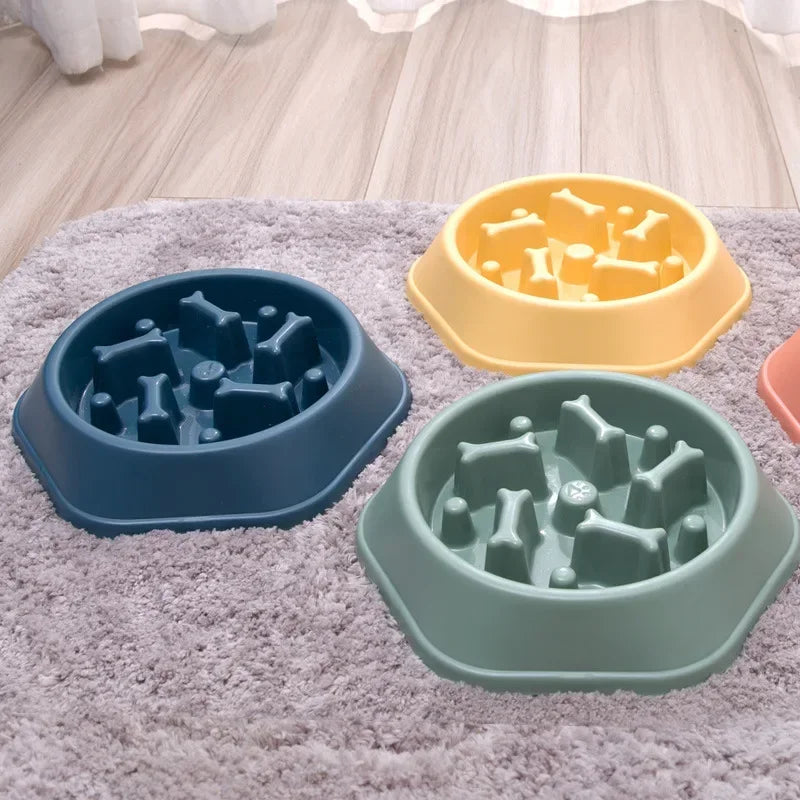 Three pet bowls with bone-shaped holes on a textured surface