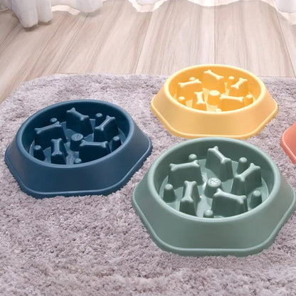 Three pet bowls with bone-shaped holes on a textured surface