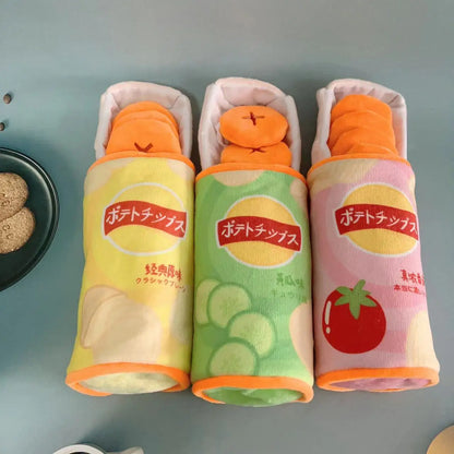 Three toy potato chip packages with colorful designs on a gray background