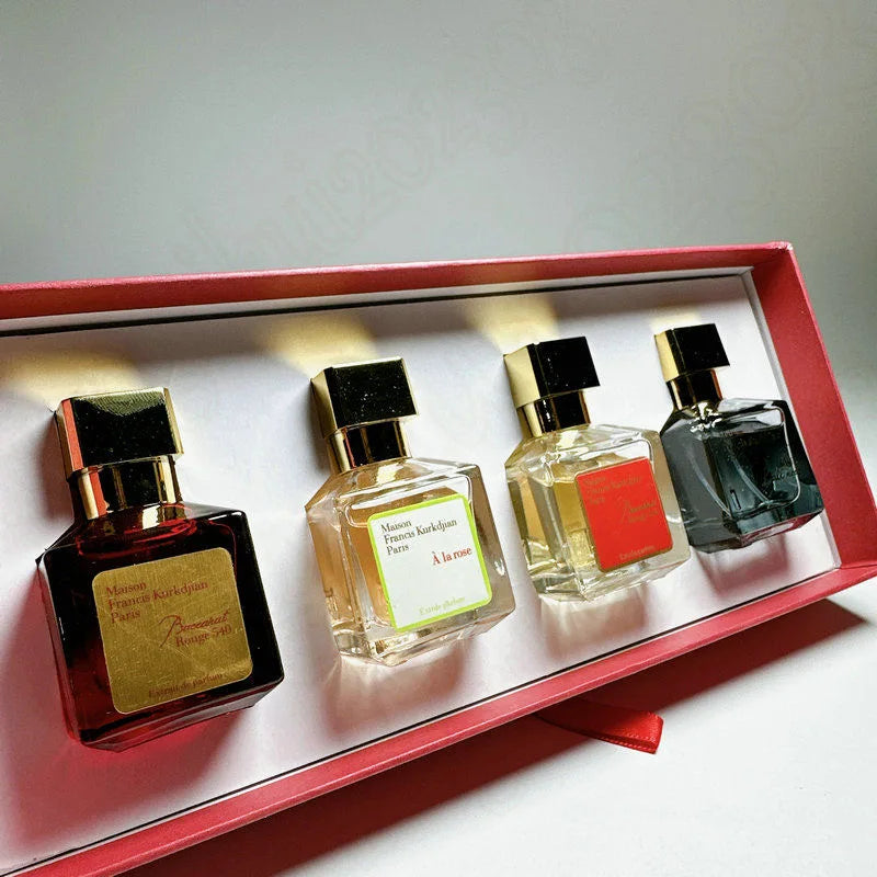 Four perfume bottles in a decorative box on a light background