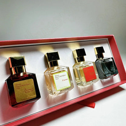 Four perfume bottles in a decorative box on a light background