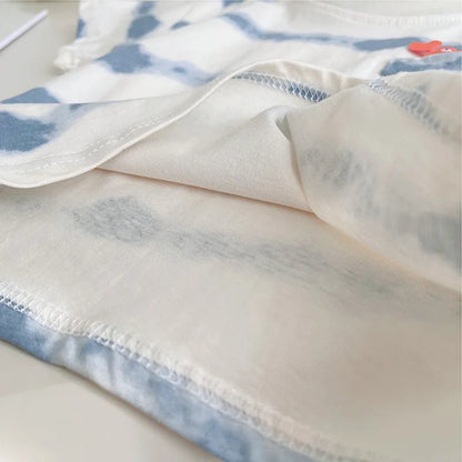 Close-up of a fabric with blue and white pattern on a light background