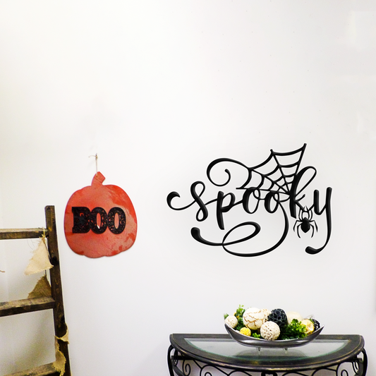 Halloween-themed wall decal with 'Spooky' and spider design on a white wall.