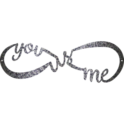 Decorative metal wall art with 'you + me' text on a white background