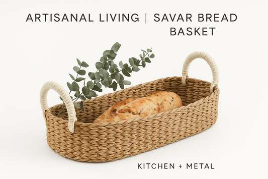 A minimalist styled image of the Savar Bread Basket with artisan bread and eucalyptus, featuring Kitchen + Metal branding